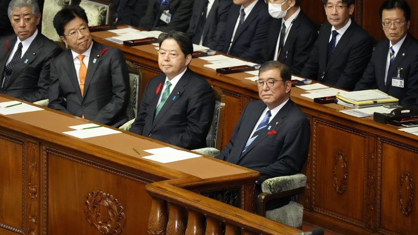 Japanese Prime Minister Shigeru Ishiba, right, attends an extraordinary Diet session at the lower house of parliament Wednesday, Oct. 9, 2024, in Tokyo. (AP Photo/Eugene Hoshiko)