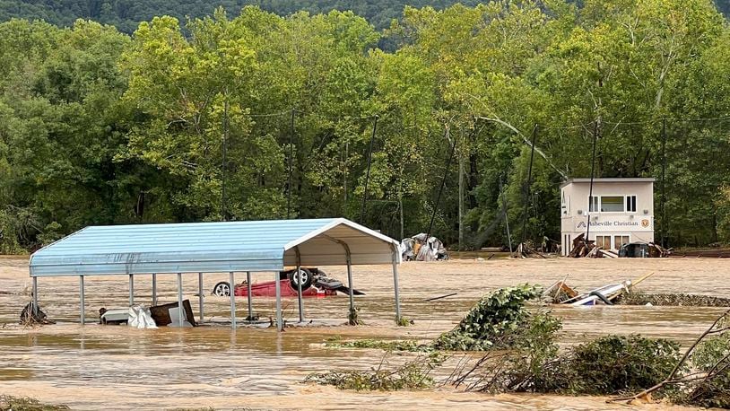 This photo provided by Kelly Benware shows flooding around the football field at Asheville Christian Academy in Swannanoa, N.C., on Friday, Sept. 27, 2024. (Kelly Benware via AP)