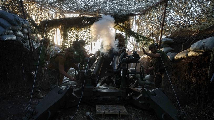 Ukrainian servicemen of 148th separate artillery brigade of the Air Assault Forces fire towards Russian positions by a M777 howitzer at the frontline in Donetsk region, Ukraine, Wednesday, August 21, 2024. (AP Photo/Evgeniy Maloletka)