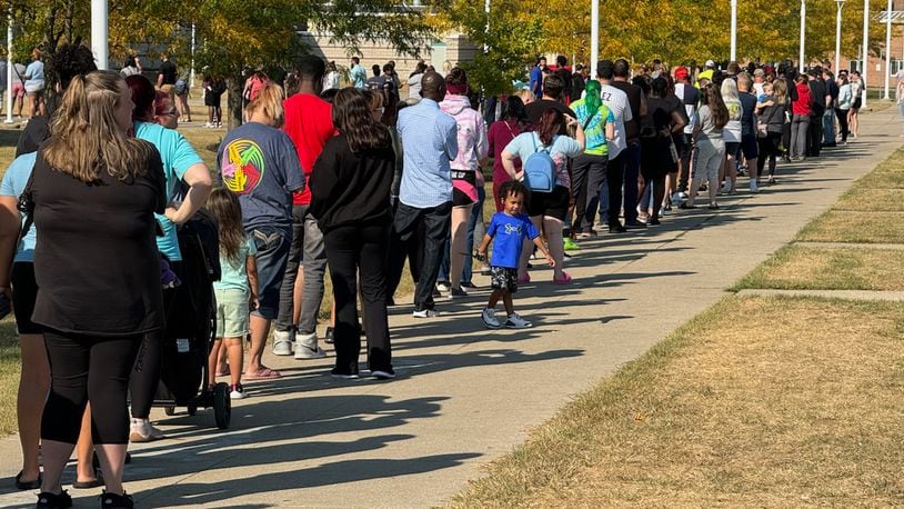 Parents wait in line at Springfield High School to pick up Simon Kenton Elementary students Monday. BILL LACKEY/STAFF