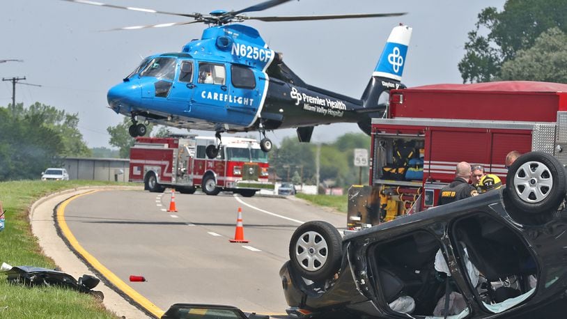 A Careflight helicopter lifts off with one of the victims of a fatal two car accident on Urbana Road just north of Ohio Route 334 Thursday, May 19, 2022. One passenger in the overturned car was killed and a person in the other car was taken by medic with non-life threatening injuries. BILL LACKEY/STAFF
