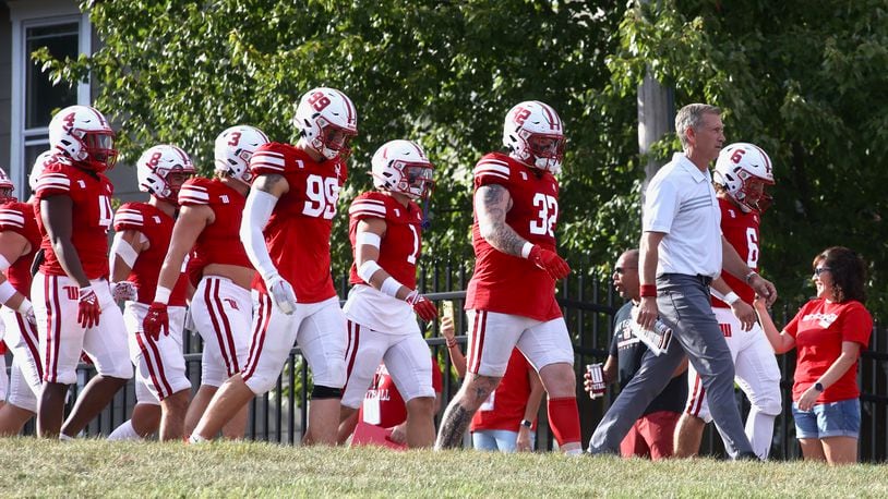 Wittenberg's Jim Collins leads the team onto the field before a game against Kenyon on Saturday, Sept. 16, 2023, at Edwards-Maurer Field in Springfield. David Jablonski/Staff