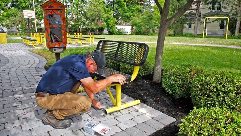 George Roach, from George's Landscaping, puts the finishing touches of a neighborhood park along Woodward Avenue in Springfield Thursday, June 6, 2024. The park will be officially dedicated Saturday to Sully Jaymes, the city's first Black attorney. BILL LACKEY/STAFF