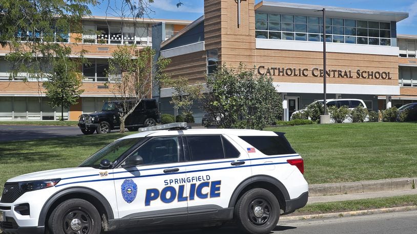 A Springfield police cruiser sits in front of Catholic Central School Friday, Sept. 23, 2022, after a false call reporting an active shooter inside the school on East High Street. BILL LACKEY/STAFF
