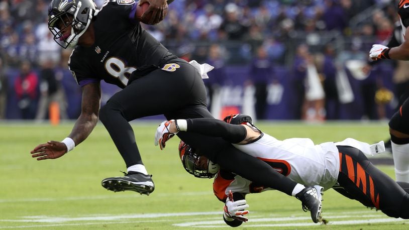 BALTIMORE, MD - NOVEMBER 18: Quarterback Lamar Jackson #8 of the Baltimore Ravens is tackled as he carries the ball by free safety Jessie Bates #30 of the Cincinnati Bengals in the first quarter at M&T Bank Stadium on November 18, 2018 in Baltimore, Maryland. (Photo by Rob Carr/Getty Images)