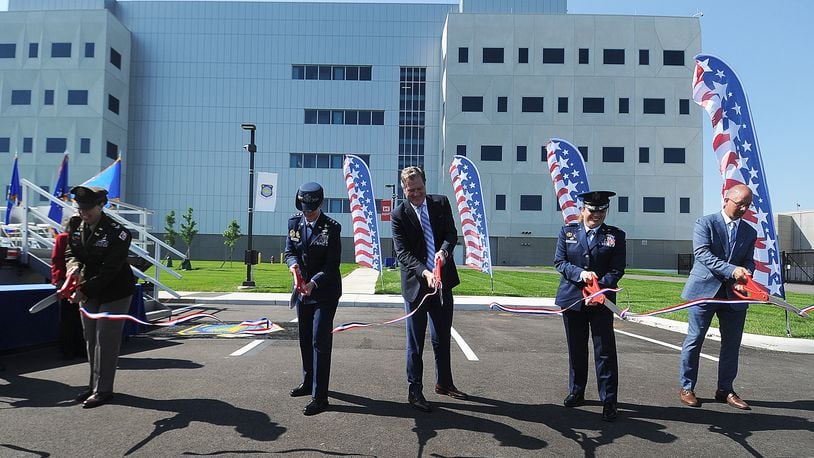 The official ribbon cutting ceremony for the National Air and Space Intelligence Center (NASIC) took place Monday, May 13, 2024. From left, Colonel L. Reyn Mann, Lt. General Leah G. Lauderback, U.S. Congressman Mike Turner, Colonel Ariel G. Batungbacal and Matthew Schnelle, Messer Construction Company. MARSHALL GORBY\STAFF