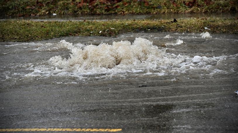 Manhole cover pops up on Nicolas Road in the 3000 block due to heavy rain Tuesday, February 22, 2022. MARSHALL GORBY \STAFF