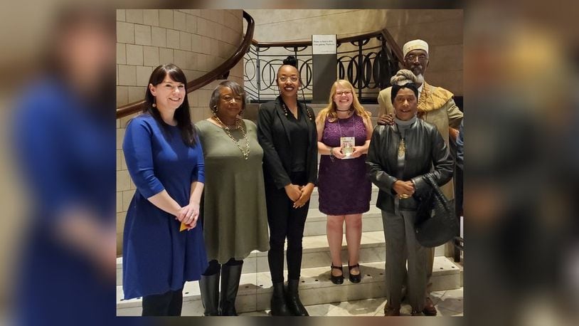 Springfield Museum of Art executive director Jessimi Jones, left, collections and exhibitions manager Elizabeth Wetterstroem, center with award, and Willis "Bing" Davis, right, were present to accept the Ohio Museums Association's Best Exhibit Award for its "Black Life as Subject Matter II" exhibition.