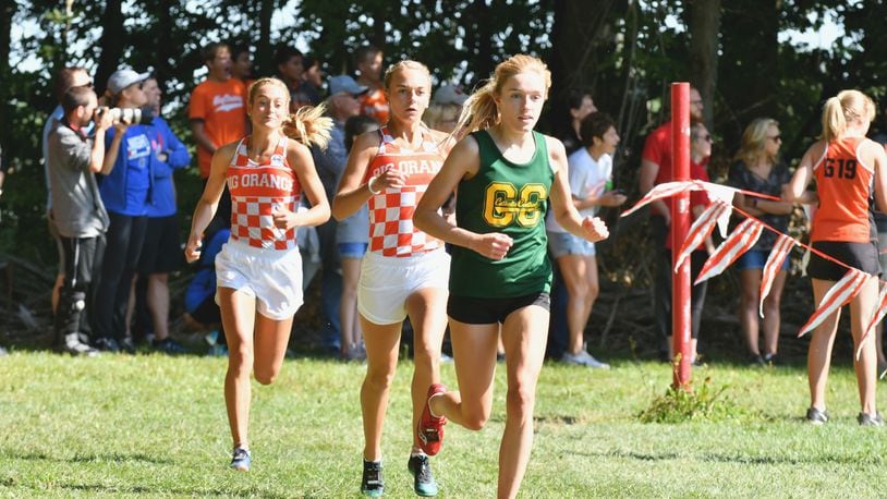 Catholic Central’s Addie Engel (front) won the small-school division at the Bob Schul Invitational on Saturday. West Liberty-Salem’s Megan Adams (middle) and Grace Adams (left) finished second and third. Greg Billing / Contributed