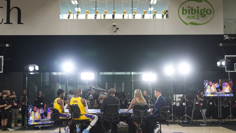 Los Angeles Lakers' LeBron James, second from left, and his son, Bronny James, sit for an interview during the NBA basketball team's media day in El Segundo, Calif., Monday, Sept. 30, 2024. (AP Photo/Jae C. Hong)