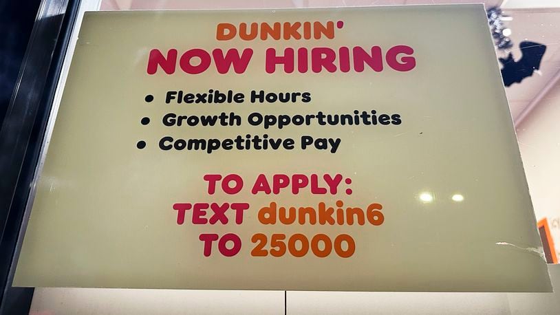 A hiring sign is displayed at a Dunkin' in Glenview, Ill., Tuesday, October. 1, 2024. (AP Photo/Nam Y. Huh)