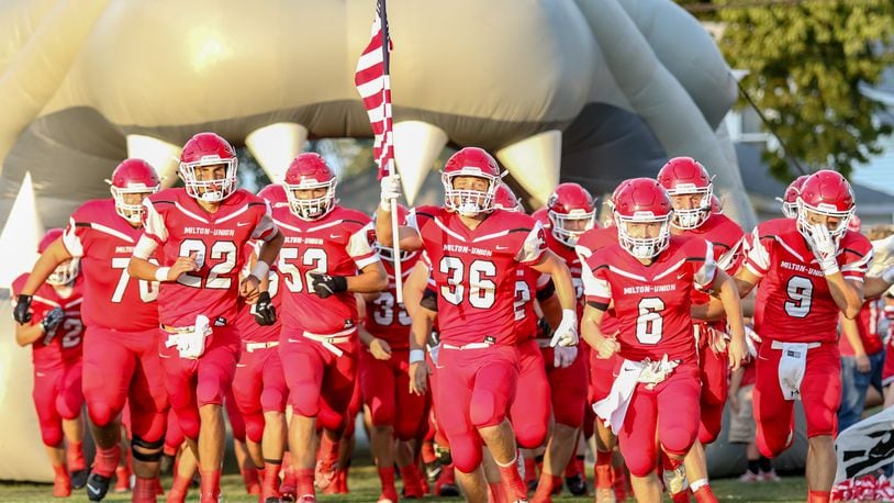 The Milton-Union High School football team runs out onto the field before its game against Northwestern on Sept. 13 at Memorial Stadium. CONTRIBUTED PHOTO BY MICHAEL COOPER