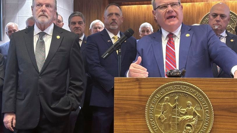 North Carolina House Speaker Tim Moore, R-Cleveland, speaks while Senate leader Phil Berger, R-Rockingham, left, and other legislators listen in the Legislative Building in Raleigh, N.C., as Berger and Moore unveiled details of an initial Hurricane Helene package considered at the General Assembly on Wednesday, Oct. 9, 2024 (AP Photo/Gary D. Robertson).