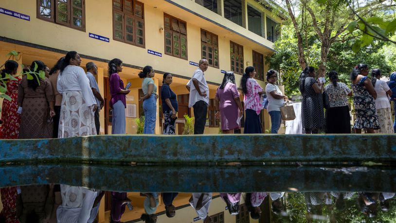 People wait in a queue to cast their votes at a polling center during the presidential election on the outskirts of Colombo, Sri Lanka Saturday, Sept. 21, 2024.(AP Photo/Rajesh Kumar Singh)