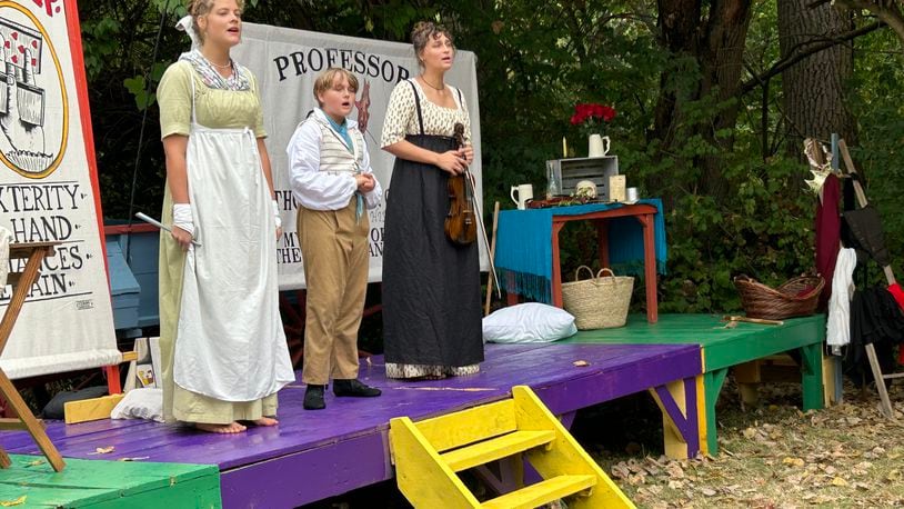 After years of attending the Fair at New Boston as reenactors, Olivia Fashian, left, Caleb Wachtman and Ava Wachtman formed their own act, the Wandering Minstrels of Rush Acadamie, performing a blend of music and comedy that debuted on Saturday at George Rogers Clark Park. CONTRIBUTED PHOTO BY BRETT TURNER