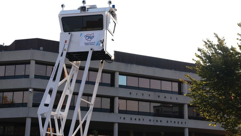 An Ohio Department of Public Safety surveillance tower rises over the parking lot across the street from Springfield City Hall on the morning of Monday, Sept. 16, 2024. BILL LACKEY / STAFF