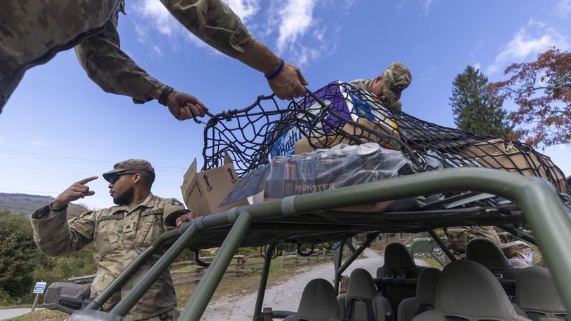 Soldiers with the 101st Airborne Division Air Assault, 2nd Brigade Combat Team, from Fort Campbell, Kentucky, use Infantry Squad Vehicles to deliver water, food, toiletries, and other aid to residents in the Soco Gap community in Maggie Valley on Tuesday, October. 8, 2024. The team has been using the Maggie Valley Pavilion and Town Hall as a distribution base for relief efforts in the town following Tropical Storm Helene. (Travis Long/The News & Observer via AP)