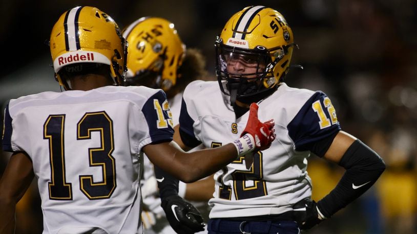 Springfield's Jamil Miller, left, congratulates Quenta Wafer Jr. after his second interception of the second half against Centerville in a Division I, Region 2 playoff game on Friday, Nov. 3, 2023, at Centerville. David Jablonski/Staff