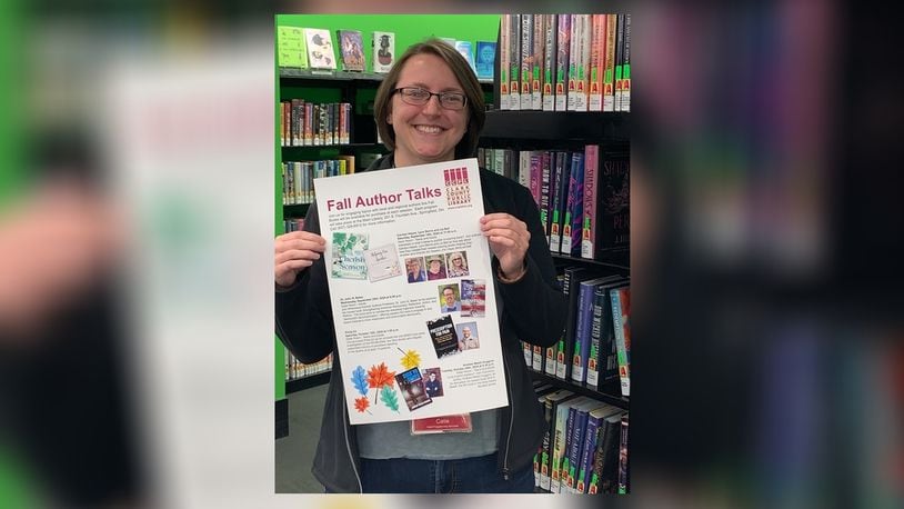 Catie Stewart, adult programming coordinator, holding a poster for the author series. Contributed