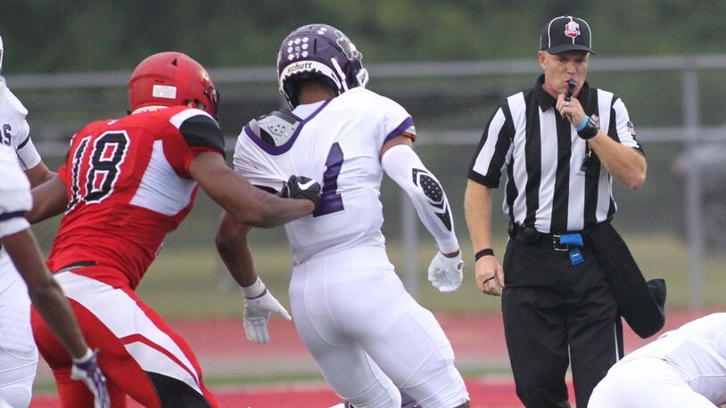 Brian Samborsky, right, officiates a game between Trotwood-Madison and Pickerington Central on Sept. 7, 2018, in Trotwood. David Jablonski/Staff