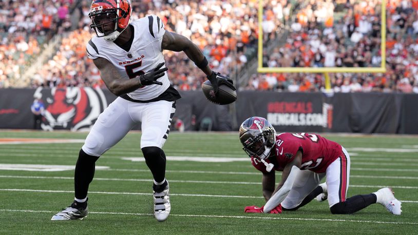 Cincinnati Bengals wide receiver Tee Higgins (5) gets past Tampa Bay Buccaneers defensive back Josh Hayes (32) as Higgins scores a touchdown in the first half of an NFL preseason football game Saturday, Aug. 10, 2024, in Cincinnati. (AP Photo/Jeff Dean)