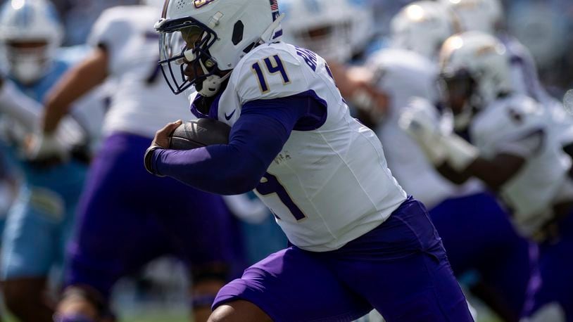 James Madison quarterback Alonza Barnett III (14) drives the ball around North Carolina defense during the first half of an NCAA college football game in Chapel Hill, N.C., Saturday, Sept. 21, 2024. (Daniel Lin/Daily News-Record via AP)