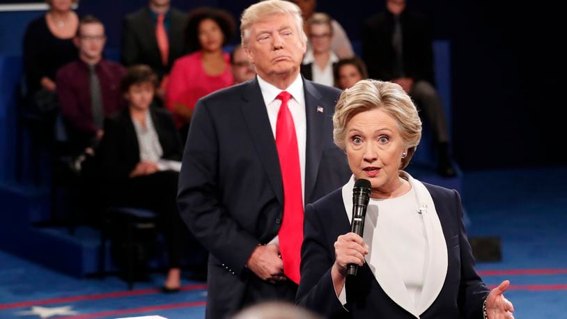 FILE - Democratic presidential nominee Hillary Clinton, right, speaks as Republican presidential nominee Donald Trump listens during the second presidential debate in St. Louis, Oct. 9, 2016. (Rick T. Wilking/Pool via AP, File)