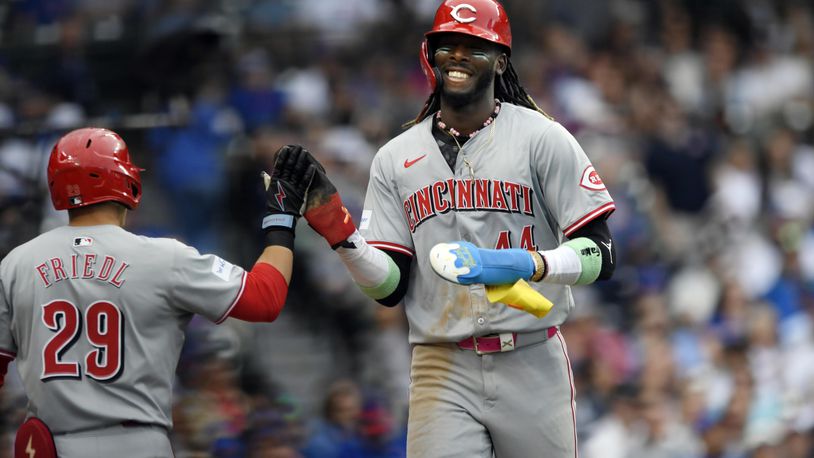 Cincinnati Reds' Elly De La Cruz (44) celebrates with teammate T.J. Friedl (29) after scoring on a Tyler Stephenson single during the tenth inning of a baseball game in Chicago, Sunday, Sept. 29, 2024. (AP Photo/Paul Beaty)