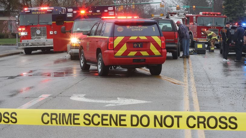 A pedestrian was killed after being struck and trapped under a work van on Belmont Avenue between High Street and Main Street Tuesday afternoon. BILL LACKEY/STAFF