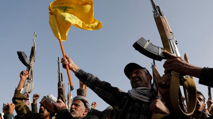 Houthi supporters raise a Hezbollah flag during an anti-Israel and anti-U.S. rally in Sanaa, Yemen, Friday, Sept. 27, 2024. (AP Photo/Osamah Abdulrahman)