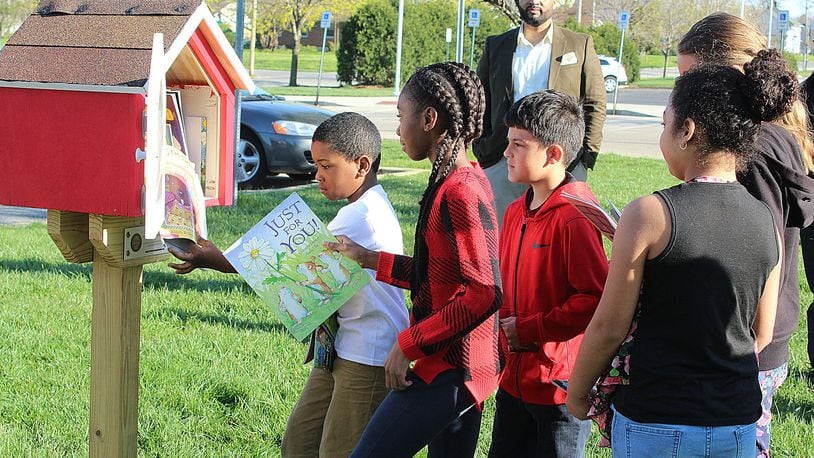 Students from Lincoln Elementary School in Springfield put books in one of the Houses of Knowledge dedicated Monday April 30, 2018. A total of seven Houses of Knowledge were installed at schools in the district. JEFF GUERINI/STAFF