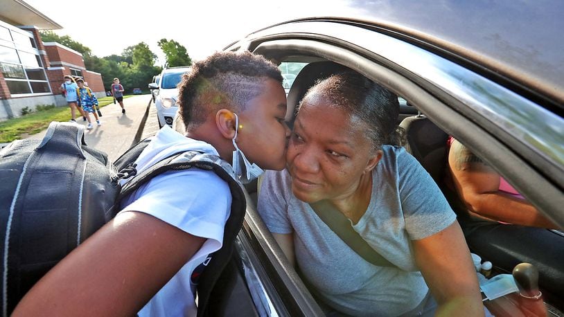 Sean Kidd gives his grandmother, Kim Martin, a kiss goodbye as he gets dropped off for the first day of school at Lagonda Elementary in August 2021. BILL LACKEY/STAFF