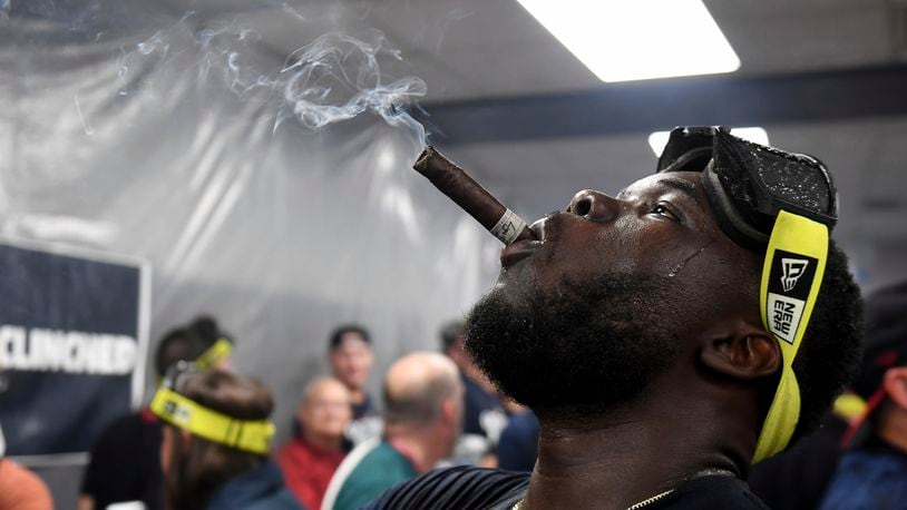 Cleveland Guardians' Jhonkensy Noel celebrates in the clubhouse after they defeated the Minnesota Twins to clinch a baseball playoff berth, Thursday, Sept. 19, 2024, in Cleveland. (AP Photo/Nick Cammett)