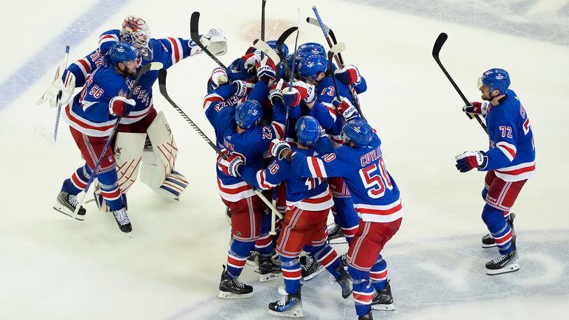 The New York Rangers celebrate after beating the Florida Panthers in overtime of Game 2 during the Eastern Conference finals of the NHL hockey Stanley Cup playoffs, Friday, May 24, 2024, in New York. (AP Photo/Julia Nikhinson)