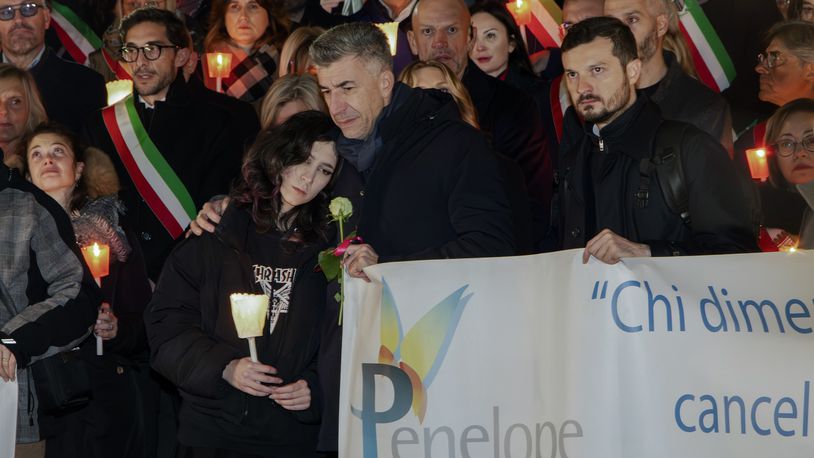 FILE - Gino Cecchettin, hugging his daughter Elena, attends a torchlit procession in Vigonovo, near Venice, northern Italy, Sunday, Nov. 19, 2023, after the police found the body of his other daughter Giulia. (Lucrezia Granzetti/LaPresse via AP)