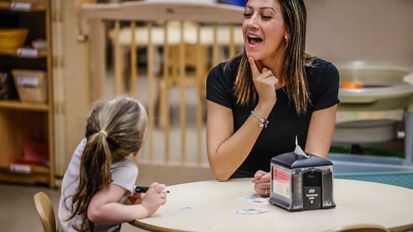 Mini University at Sinclair Community College PreK student teacher, Alex Ooten, works with a student Wednesday, April 5, 2023. JIM NOELKER/STAFF