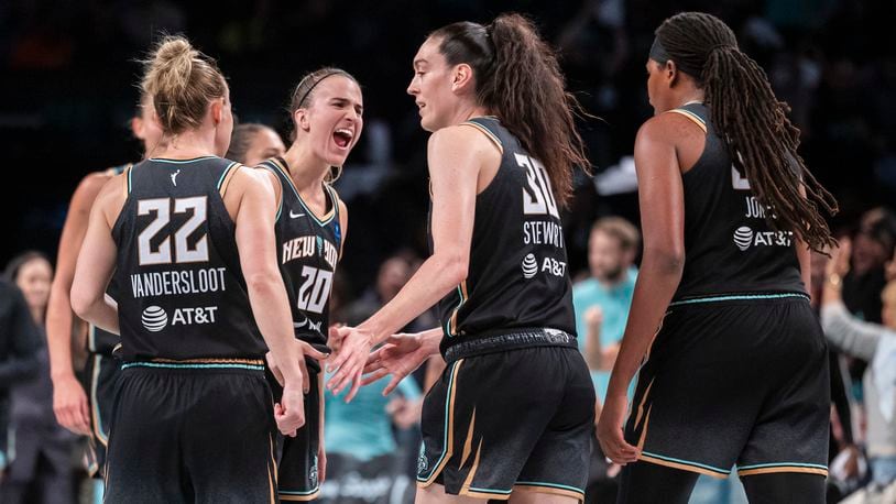 New York Liberty guard Sabrina Ionescu (20) celebrates with forward Breanna Stewart (30) during the second half of a WNBA basketball second-round playoff game against the Las Vegas Aces, Sunday, Sept. 29, 2024, in New York. (AP Photo/Corey Sipkin)