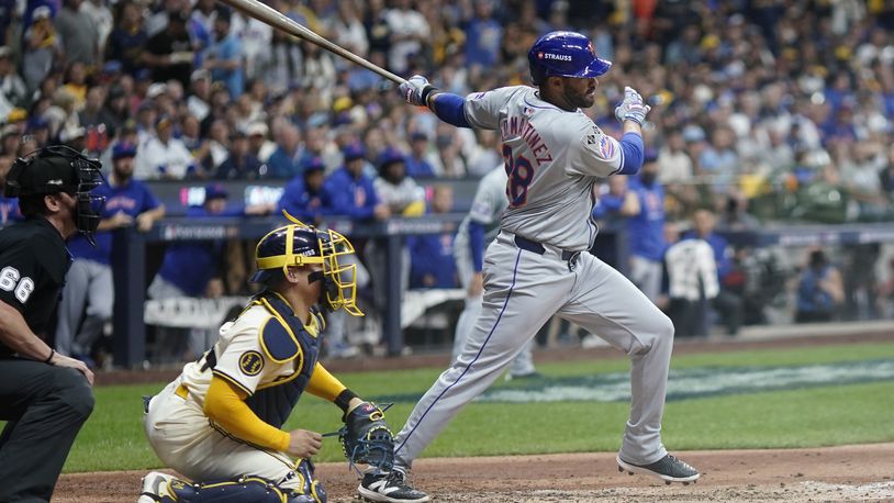 New York Mets' J.D. Martinez hits a two-run scoring single during the fifth inning of Game 2 of a National League wild card baseball game against the Milwaukee Brewers Tuesday, Oct. 1, 2024, in Milwaukee. (AP Photo/Morry Gash)