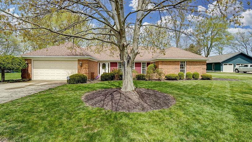 The 3-bedroom, brick ranch home offers about 2,090 sq. ft. of living space. The front of the home has a courtyard with brick wall surround, mature trees and attached, 2-car garage. CONTRIBUTED PHOTO