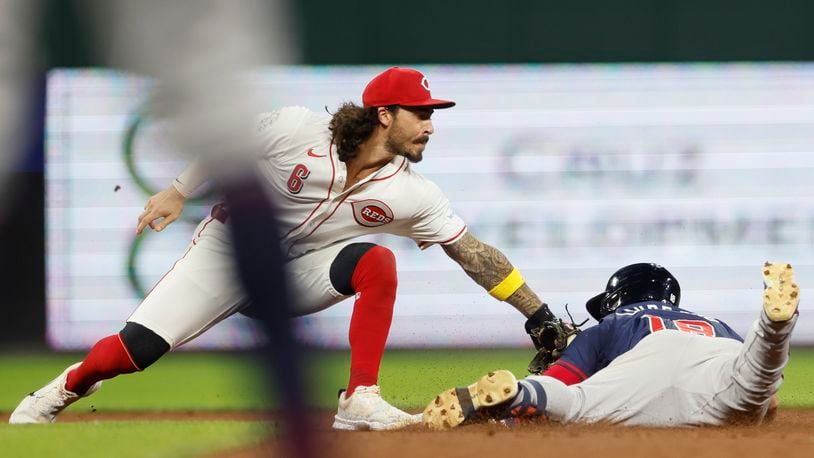 Cincinnati Reds second baseman Jonathan India, left, tries to tag Atlanta Braves' Ramon Laureano during the seventh inning of a baseball game, Wednesday, Sept. 18, 2024, in Cincinnati. Laureano was safe at second base. (AP Photo/Jay LaPrete)