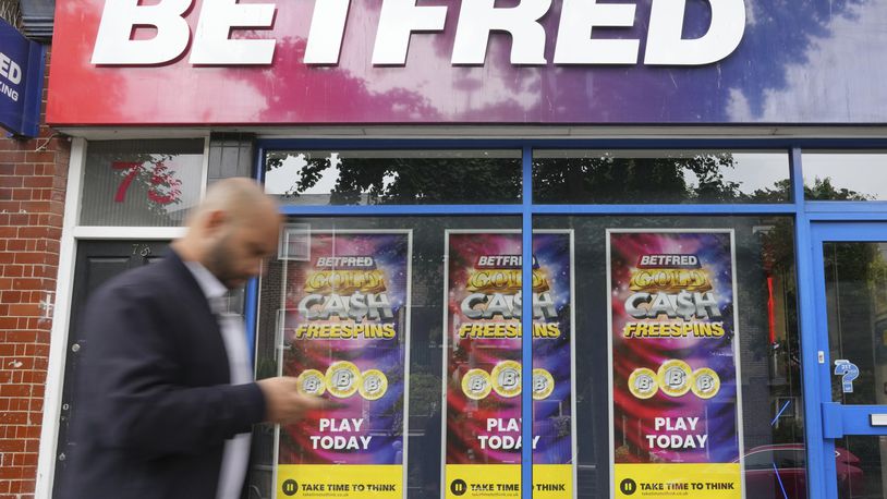 A man walks past a betting shop in London, Wednesday, July 3, 2024. Britain's general election is a big event for political gamblers. Betting on Thursday's election is expected to generate tens of millions of pounds in bets though the biggest event is a bit of a snooze. (AP Photo/Kin Cheung)