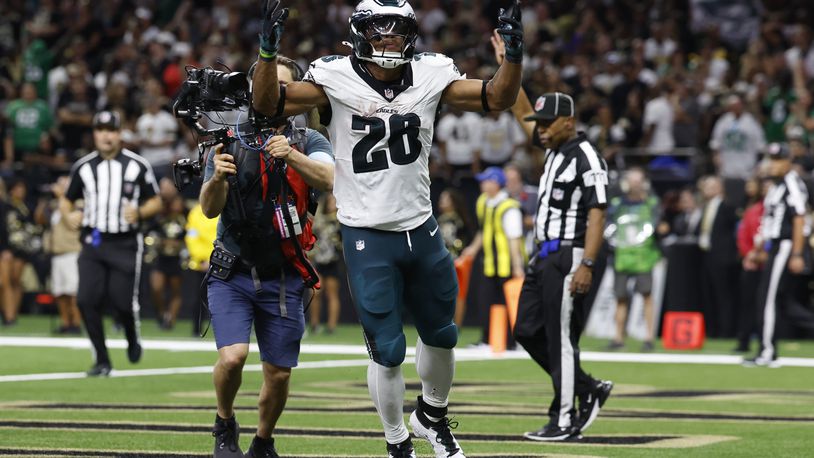 Philadelphia Eagles running back Saquon Barkley (26) celebrates after scoring a two-point conversion against the New Orleans Saints in the second half of an NFL football game in New Orleans, Sunday, Sept. 22, 2024. (AP Photo/Gerald Herbert)