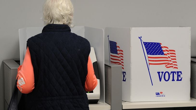 In this file photo a woman votes early at the Montgomery County Board of Elections Thursday Oct. 28, 2021. In May 2024 Ohio Secretary of State Frank LaRose announced he'll be removing the names of "inactive" voters from the state's voter registration rolls. MARSHALL GORBY\STAFF