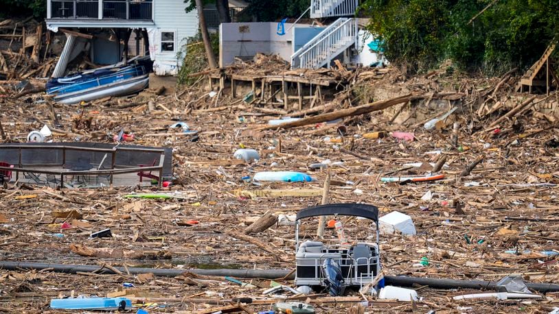 Debris is strewn on the lake in the aftermath of Hurricane Helene, Wednesday, Oct. 2, 2024, in Lake Lure, N.C. (AP Photo/Mike Stewart)