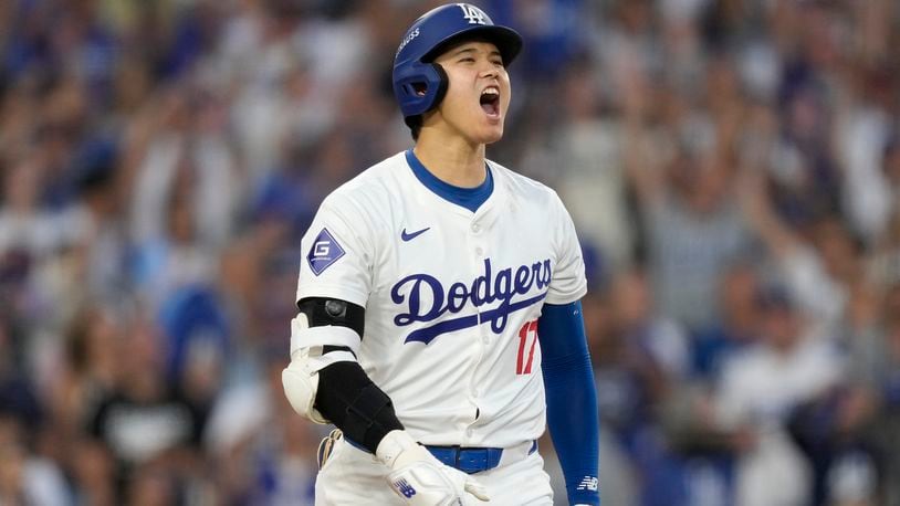 Los Angeles Dodgers' Shohei Ohtani reacts after hitting a three-run home run during the second inning in Game 1 of baseball's NL Division Series against the San Diego Padres, Saturday, Oct. 5, 2024, in Los Angeles. (AP Photo/Mark J. Terrill)