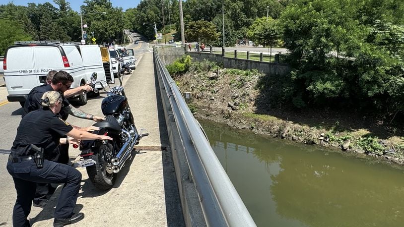 A woman riding a motorcycle was seriously injured Thursday, July 11, 2024, when she apparently lost control on the Plum Street bridge and dropped more than 30 feet into Buck Creek in downtown Springfield. BILL LACKEY/STAFF