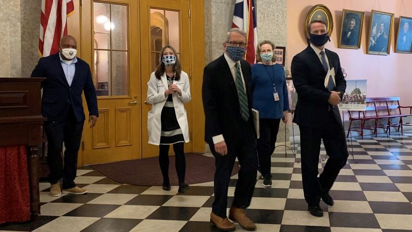 Lt. Gov. Jon Husted, Ohio Department of Health Dr. Amy Acton and Ohio Gov. Mike DeWine walk to their daily press conference. Laura Bischoff/Staff