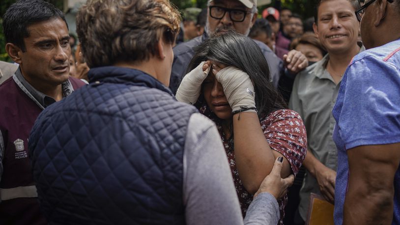 Estrella Bejarano, center, the mother of two children who died after a rain-induced landslide, speaks with Mexico State Governor Delfina Gomez in Naucalpan, Mexico, Tuesday, Sept. 17, 2024. (AP Photo/Felix Marquez)