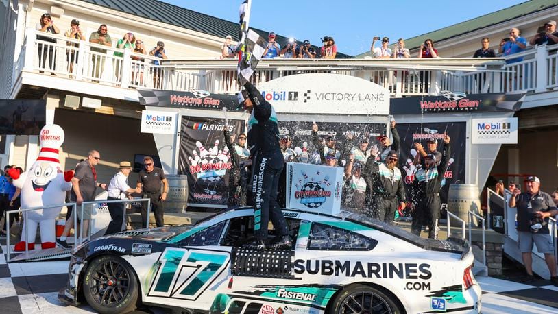 Chris Buescher (17) celebrates winning a NASCAR Cup Series auto race, Sunday, Sept. 15, 2024, in Watkins Glen, N.Y. (AP Photo/Lauren Petracca)