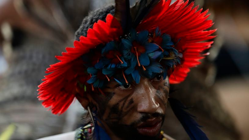 An Indigenous person attends a ceremony celebrating the return of the Tupinamba Indigenous people's sacred cloak to Brazil, in Rio de Janeiro, Thursday, Sept. 12, 2024. The garment, made from bird feathers and plant fibers, was repatriated to Brazil after having spent more than 300 years in the National Museum of Denmark. (AP Photo/Bruna Prado)